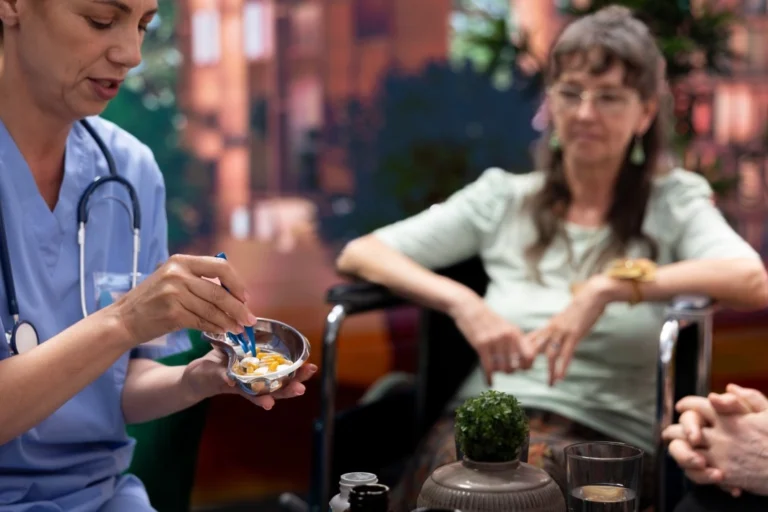 Nurse at home with disabled woman in wheelchair