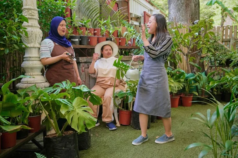 Three disabled friends in garden centre